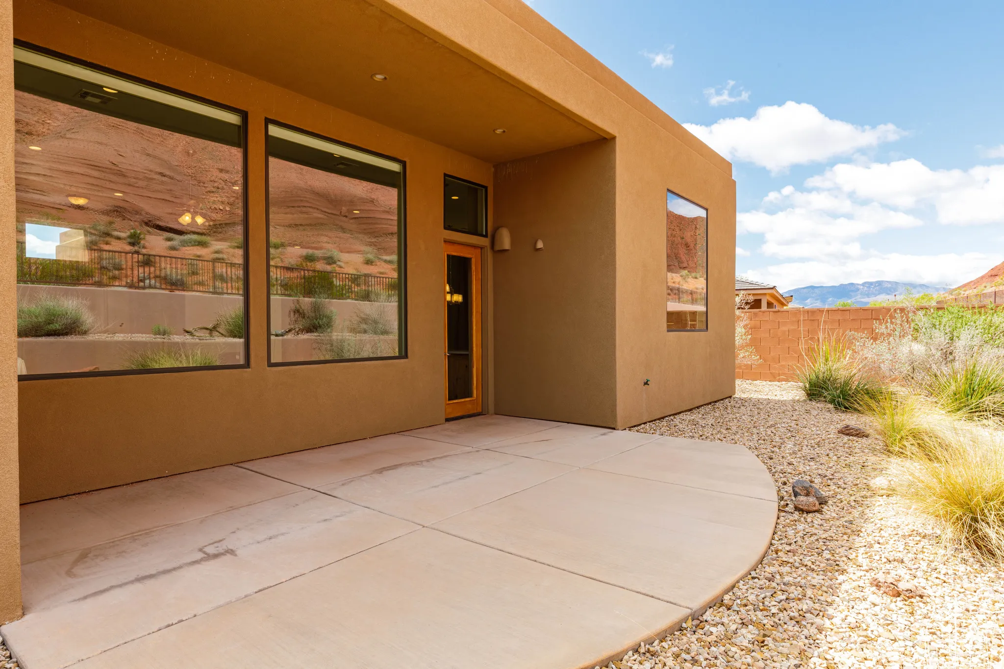 Doorway to property with a patio area, a mountain view, and stucco siding
