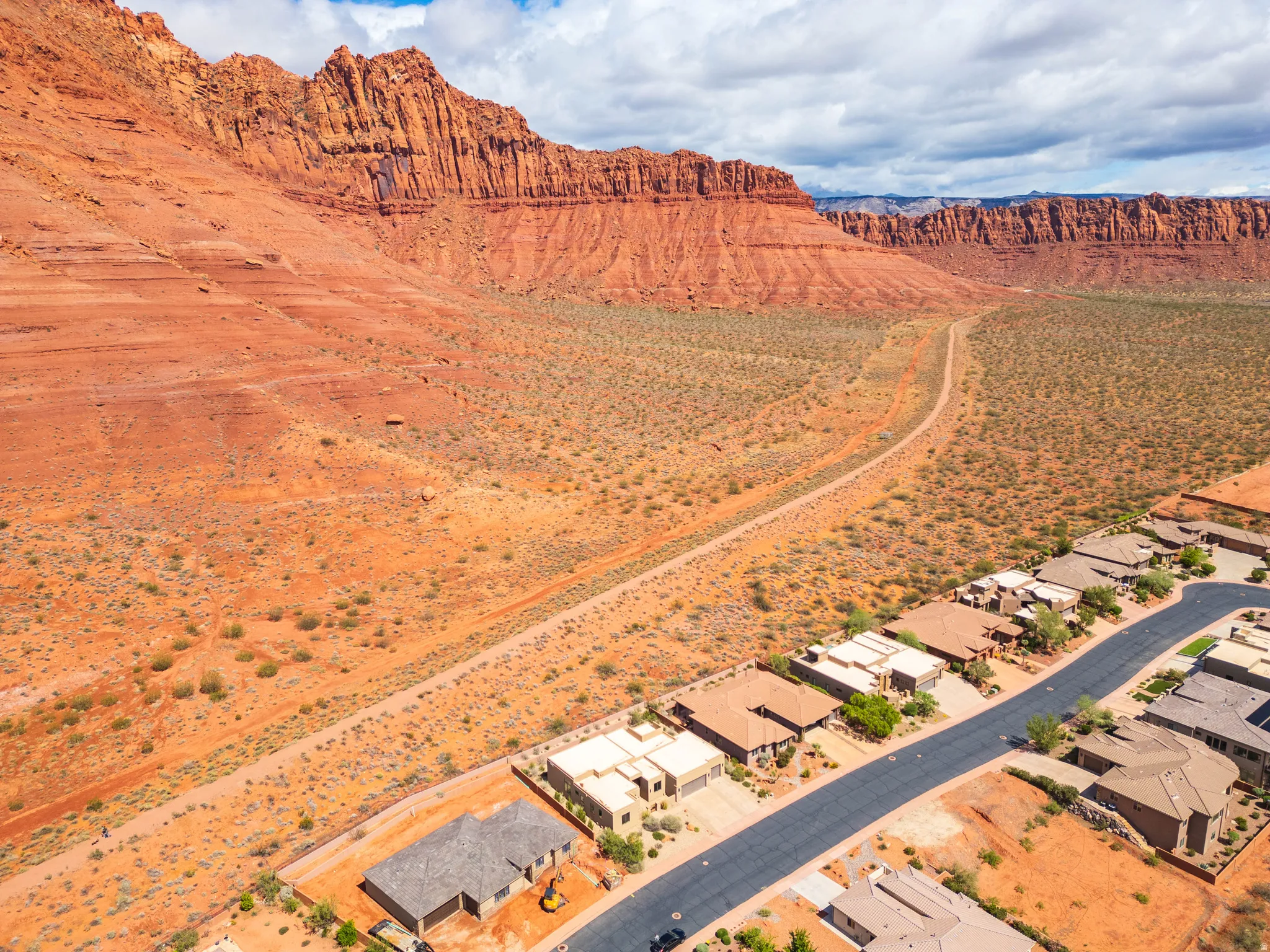 Aerial perspective of suburban area with a mountainous background and a desert landscape