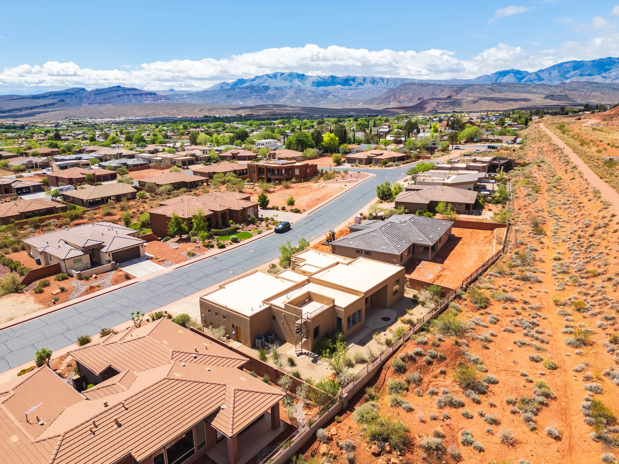 Aerial perspective of suburban area featuring a mountain backdrop