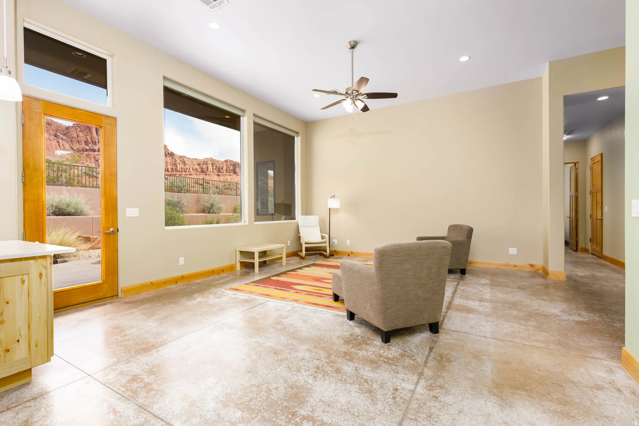 Living area featuring concrete floors, recessed lighting, a ceiling fan, and a mountain view