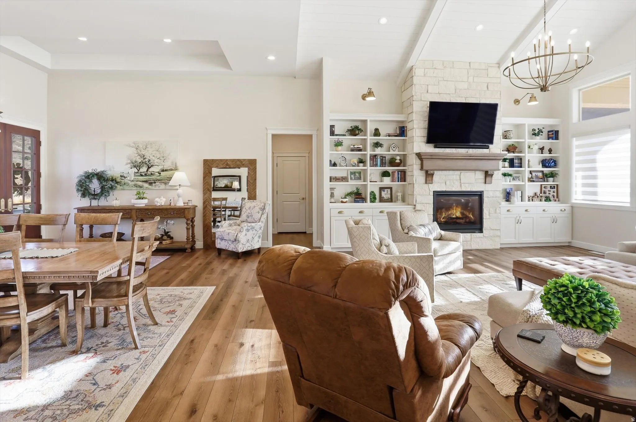 Living room with plenty of natural light, hardwood / wood-style flooring, and a high ceiling