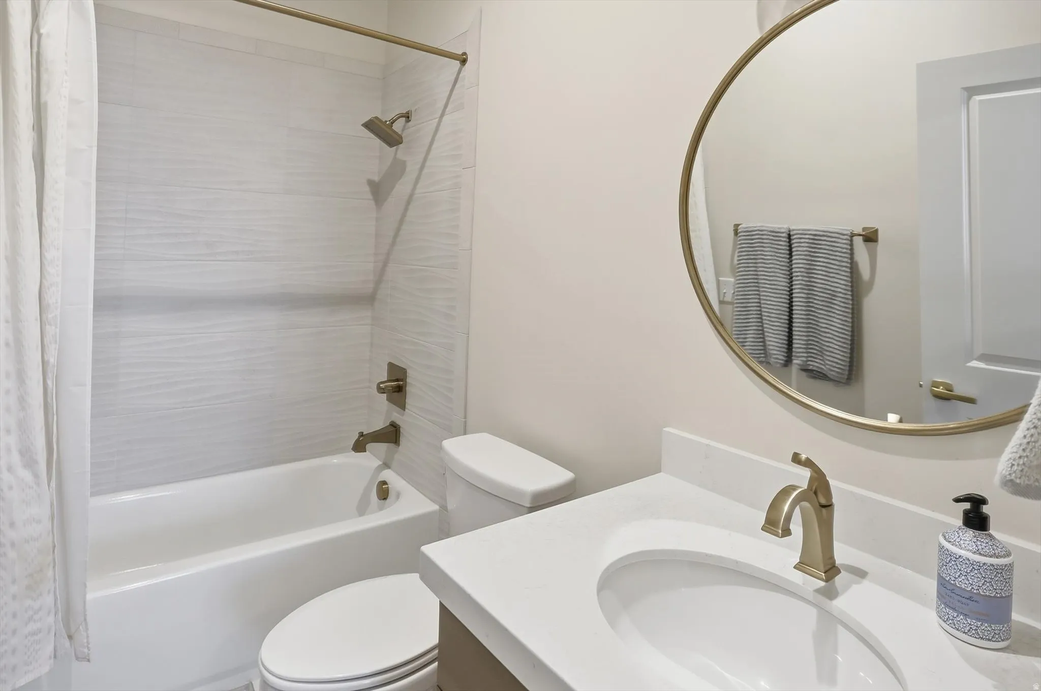 Bathroom featuring vanity and shower / tub combo with curtain