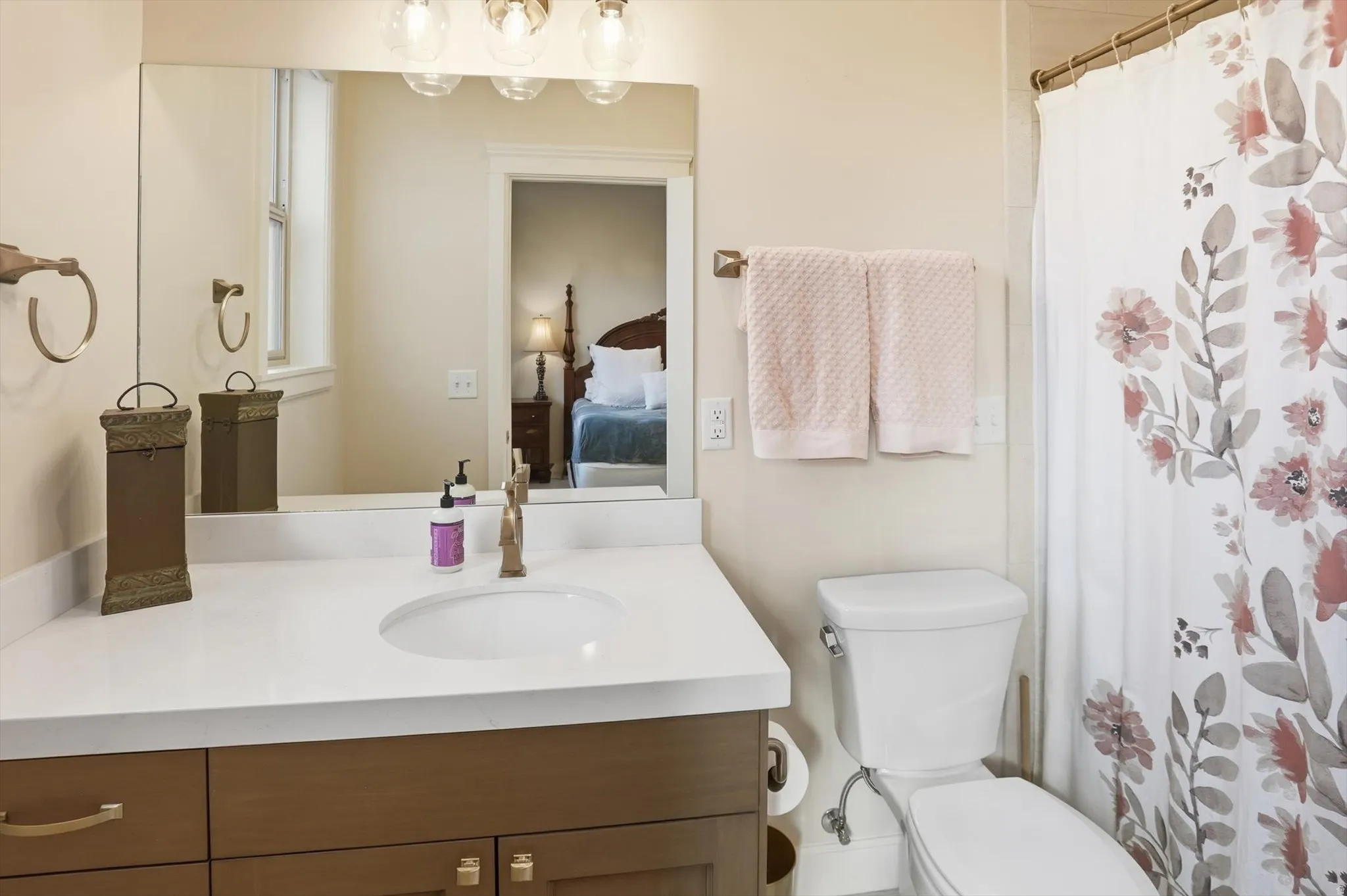 Ensuite bathroom featuring curtained shower and vanity