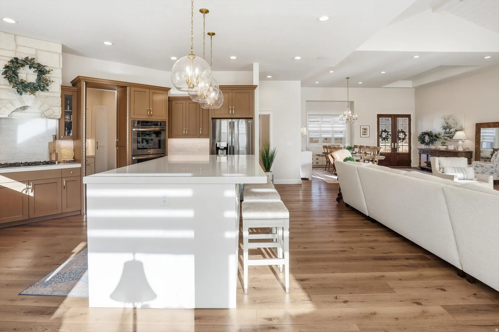 Kitchen with open floor plan, a breakfast bar area, wood finish cabinets, and a spacious island