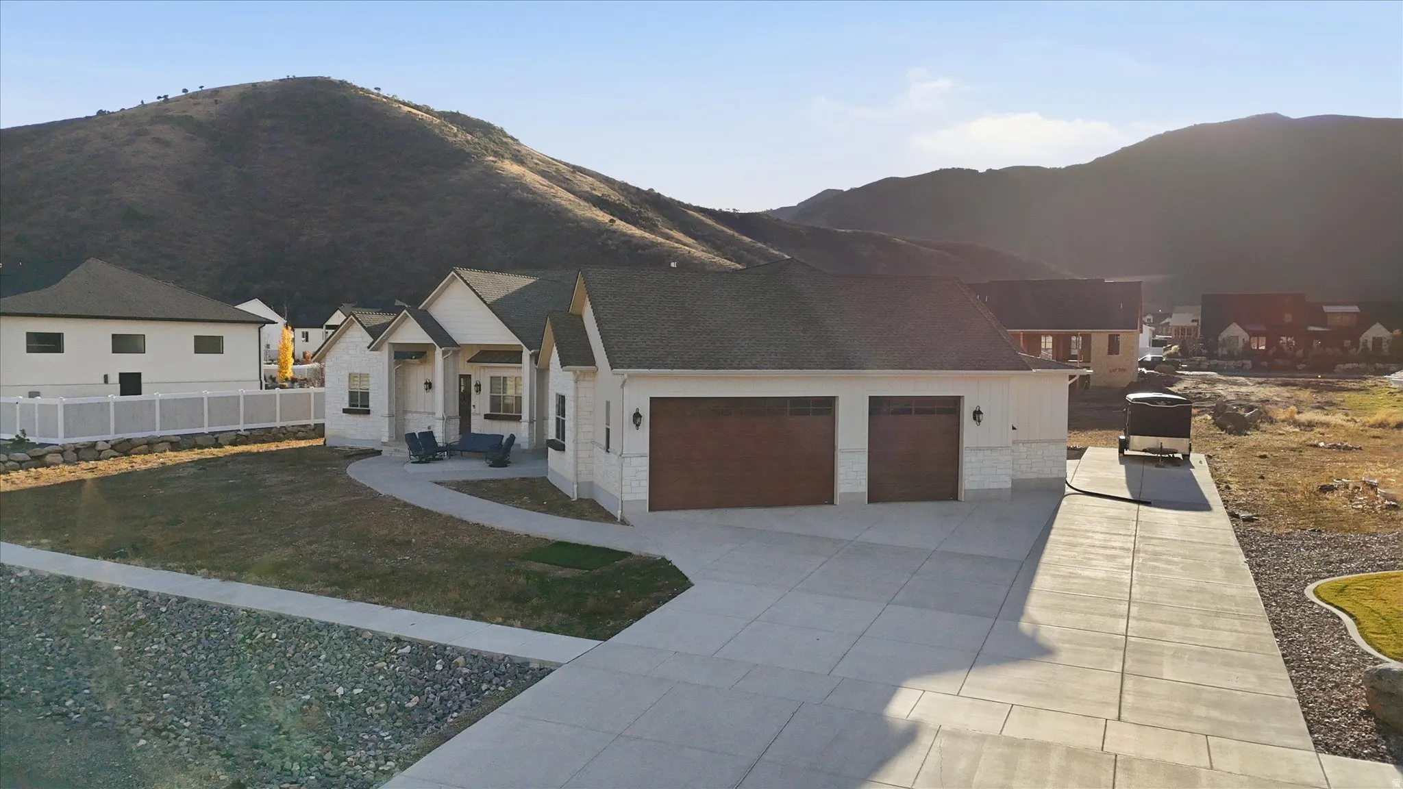 View of front of property featuring an attached garage, a mountain view, and driveway