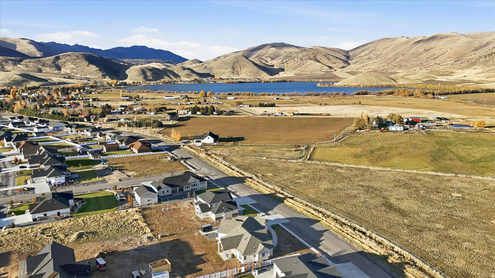 Aerial view of property's location featuring a water and mountain view and nearby suburban area