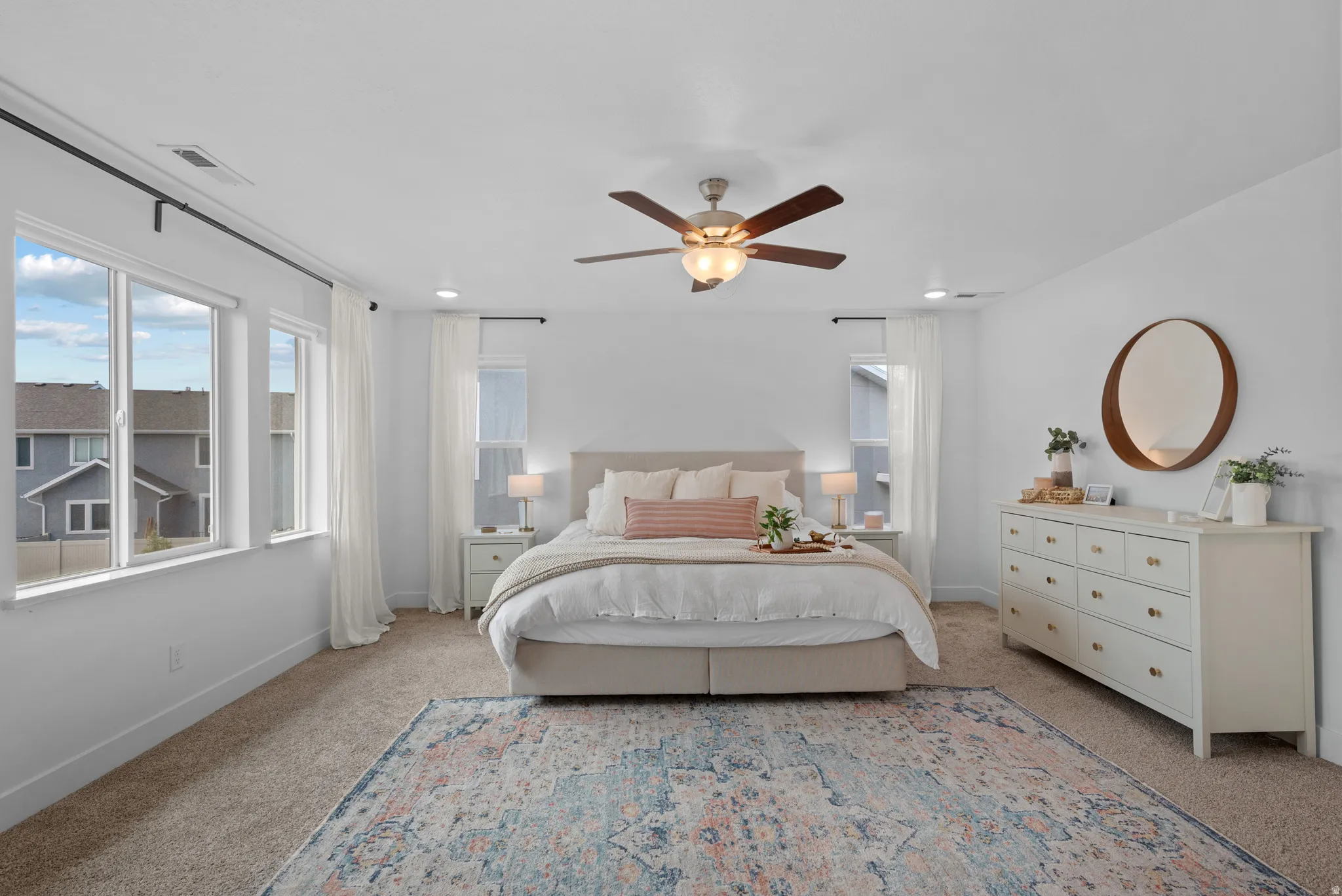 Bedroom featuring light colored carpet, a ceiling fan, and recessed lighting