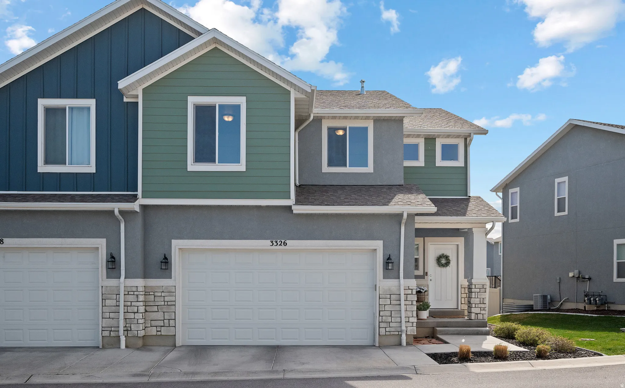 View of front of property featuring a shingled roof, board and batten siding, and stone siding