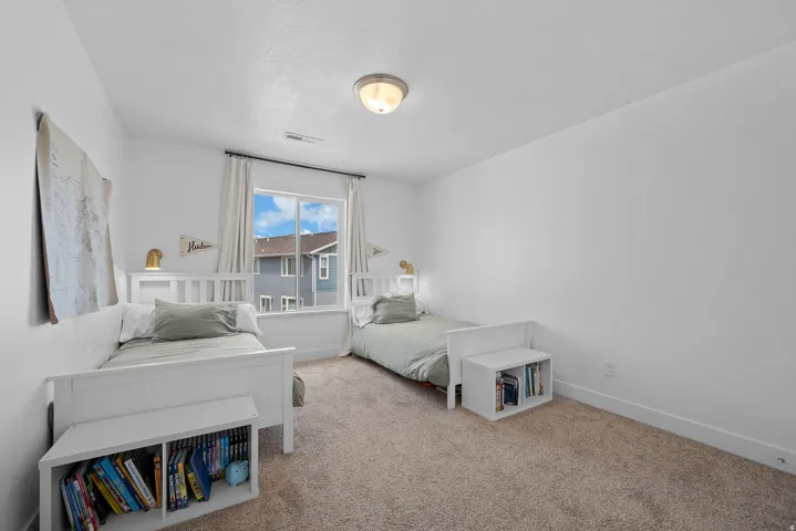 Carpeted bedroom featuring baseboards