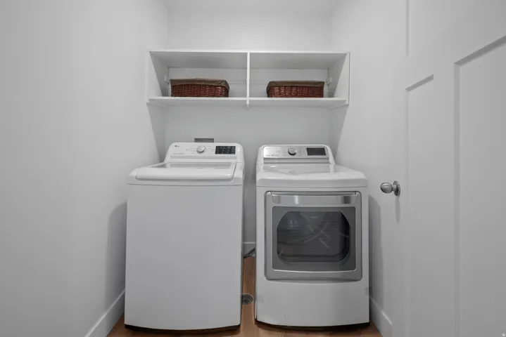 Laundry area featuring washer and dryer and light wood finished floors