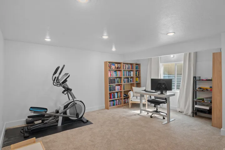 Office area with light colored carpet, recessed lighting, and a textured ceiling