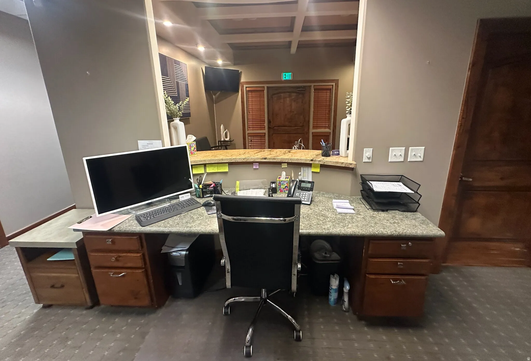 Home office with coffered ceiling and built in desk