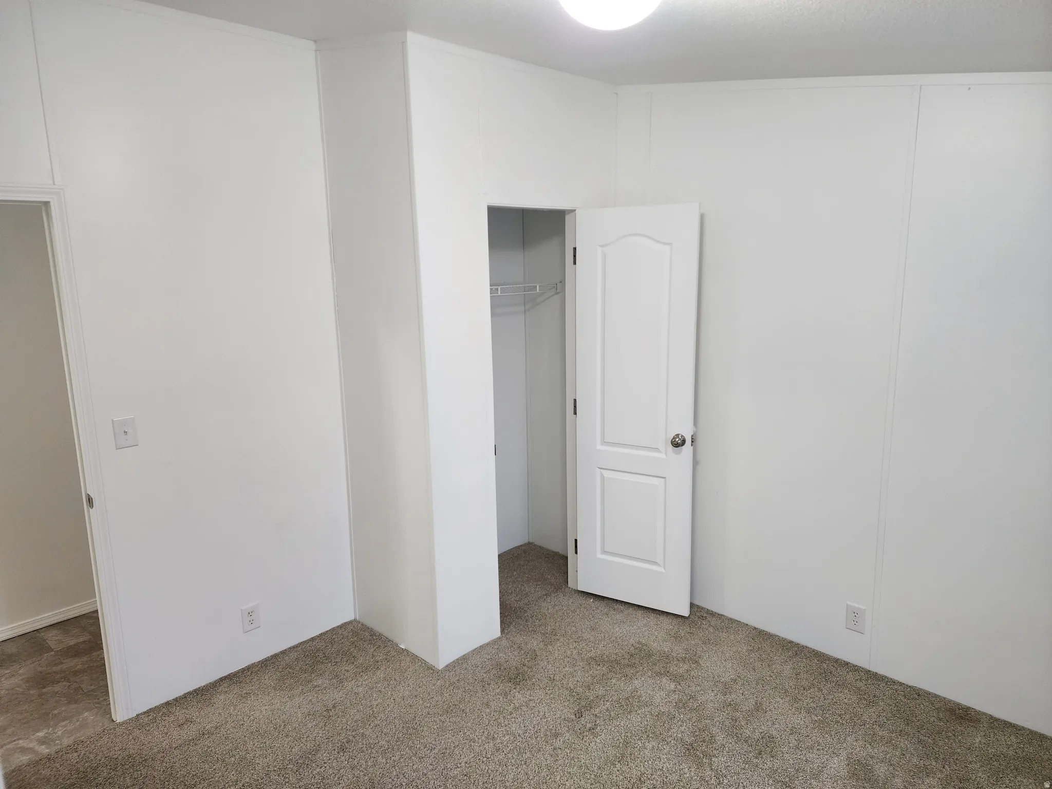 Unfurnished bedroom with carpet