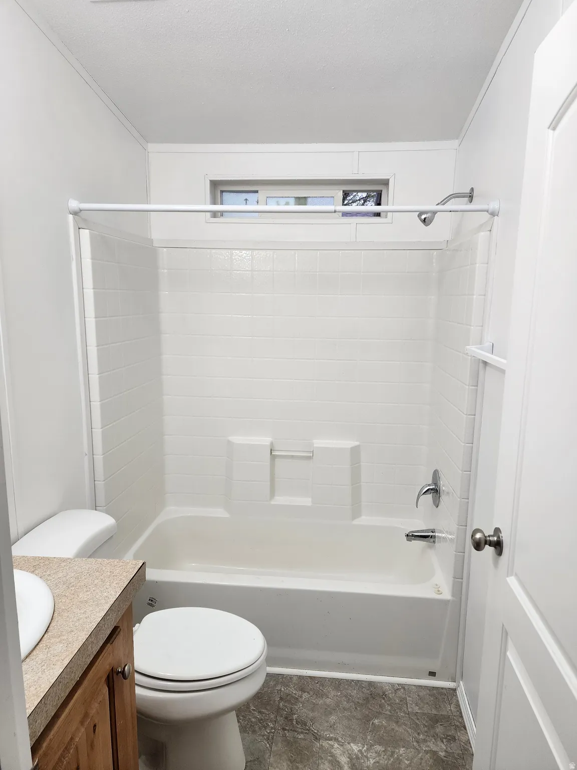 Bathroom featuring vanity,  shower combination, and crown molding