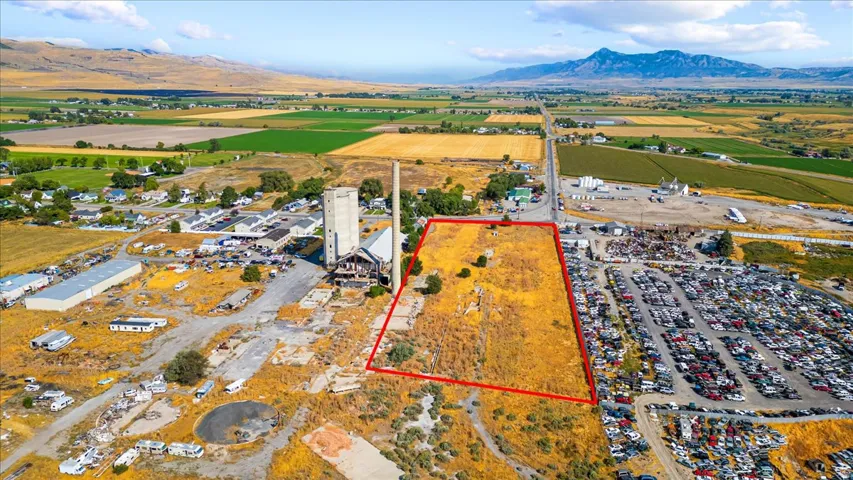 Overview of rural landscape featuring property boundaries highlighted and a mountain backdrop