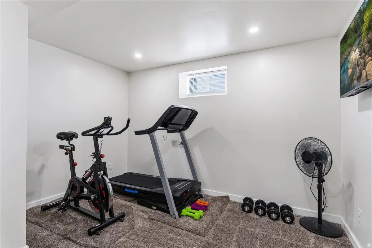Exercise room featuring carpet floors and recessed lighting
