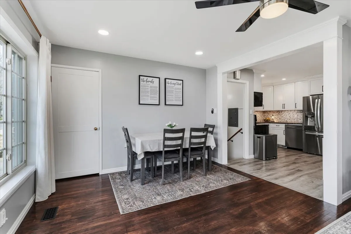 Dining space with dark wood-style flooring, a ceiling fan, and recessed lighting