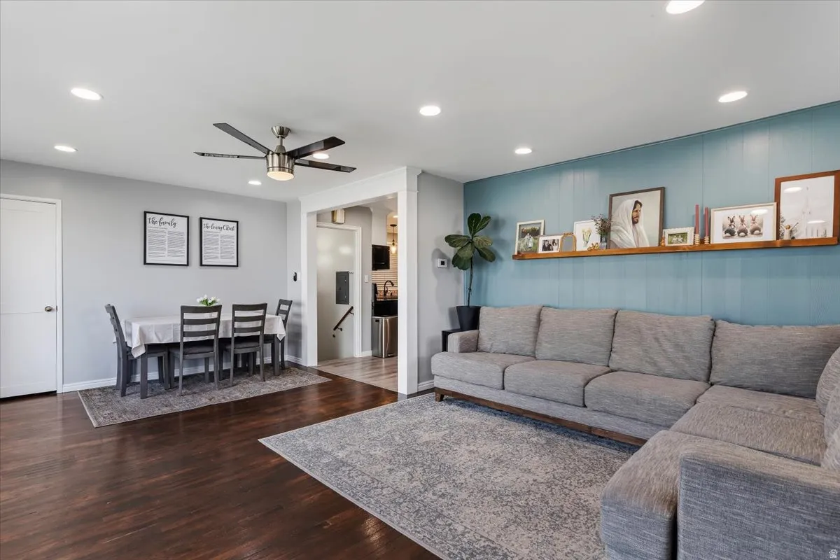 Living room featuring recessed lighting, a ceiling fan, and dark wood-style floors