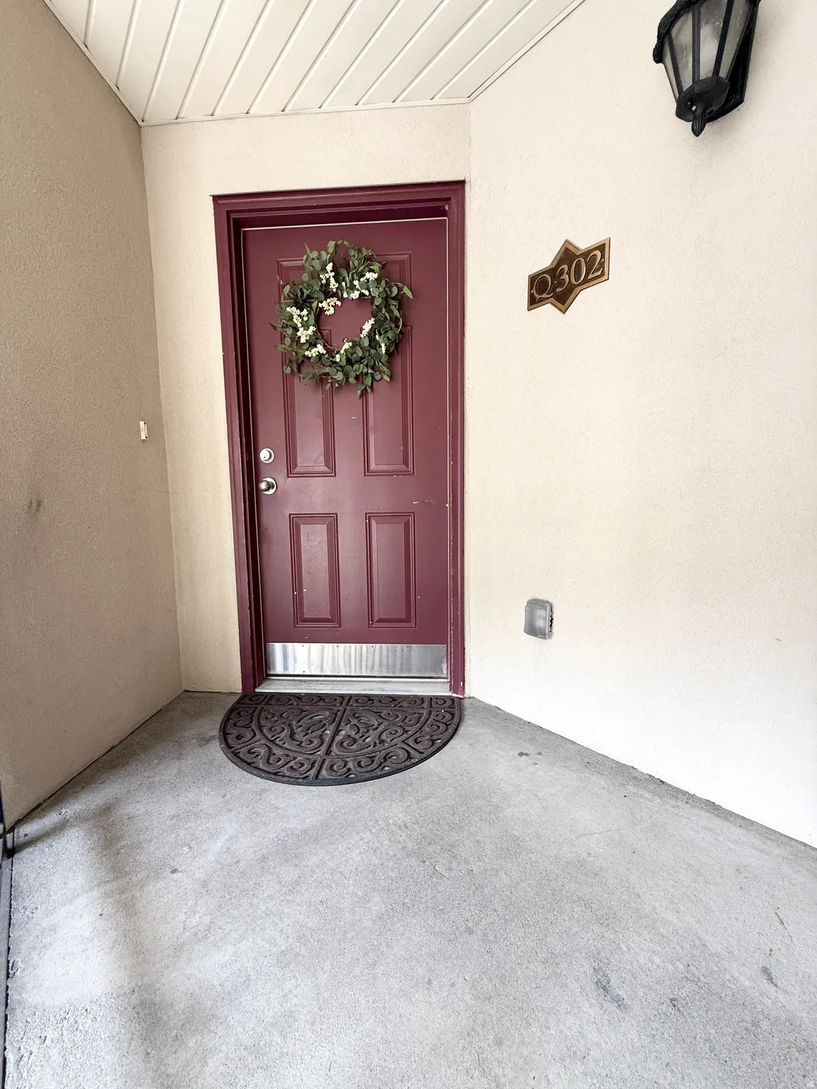 Property entrance featuring stucco siding