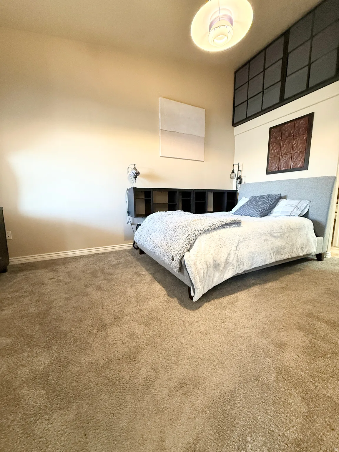 Bedroom featuring carpet floors and baseboards