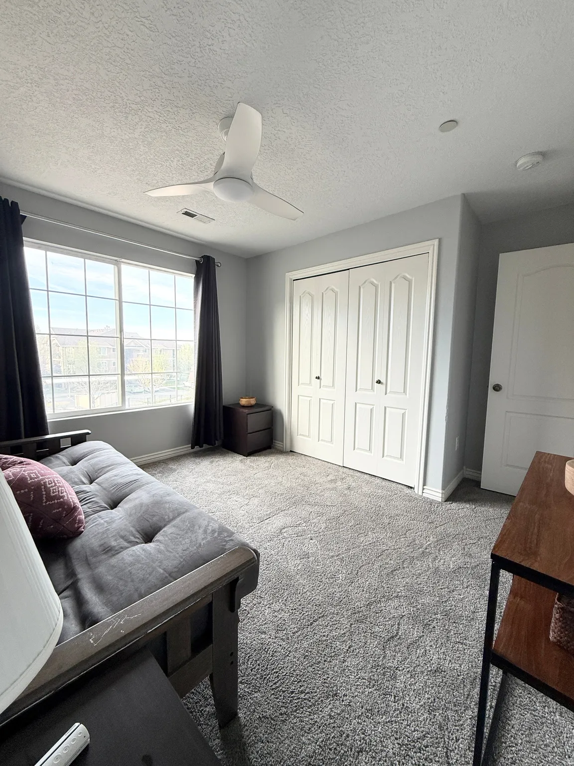 Bedroom featuring carpet, a closet, a textured ceiling, and ceiling fan