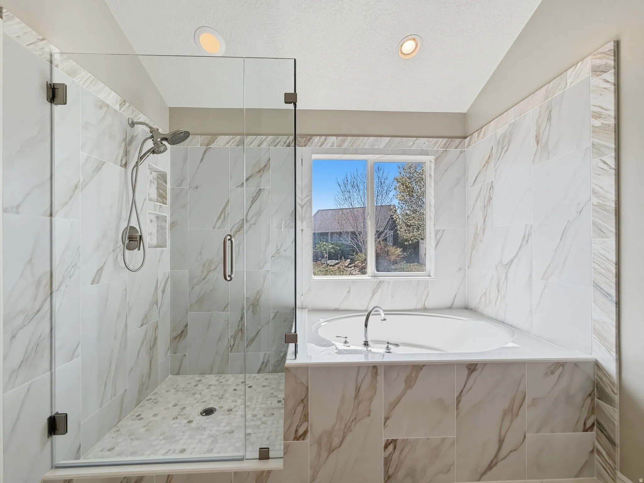 Bathroom with a marble finish shower, a garden tub, recessed lighting, and vaulted ceiling