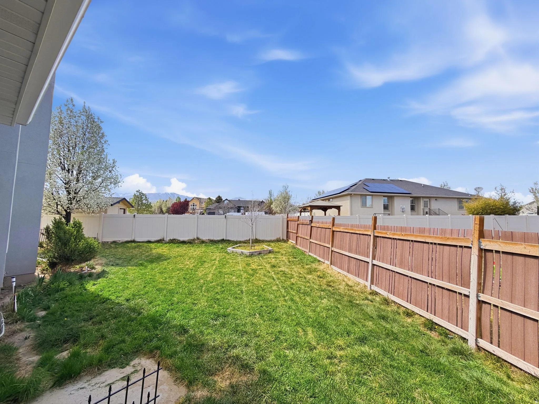 Fenced backyard with a residential view off of the kitchen