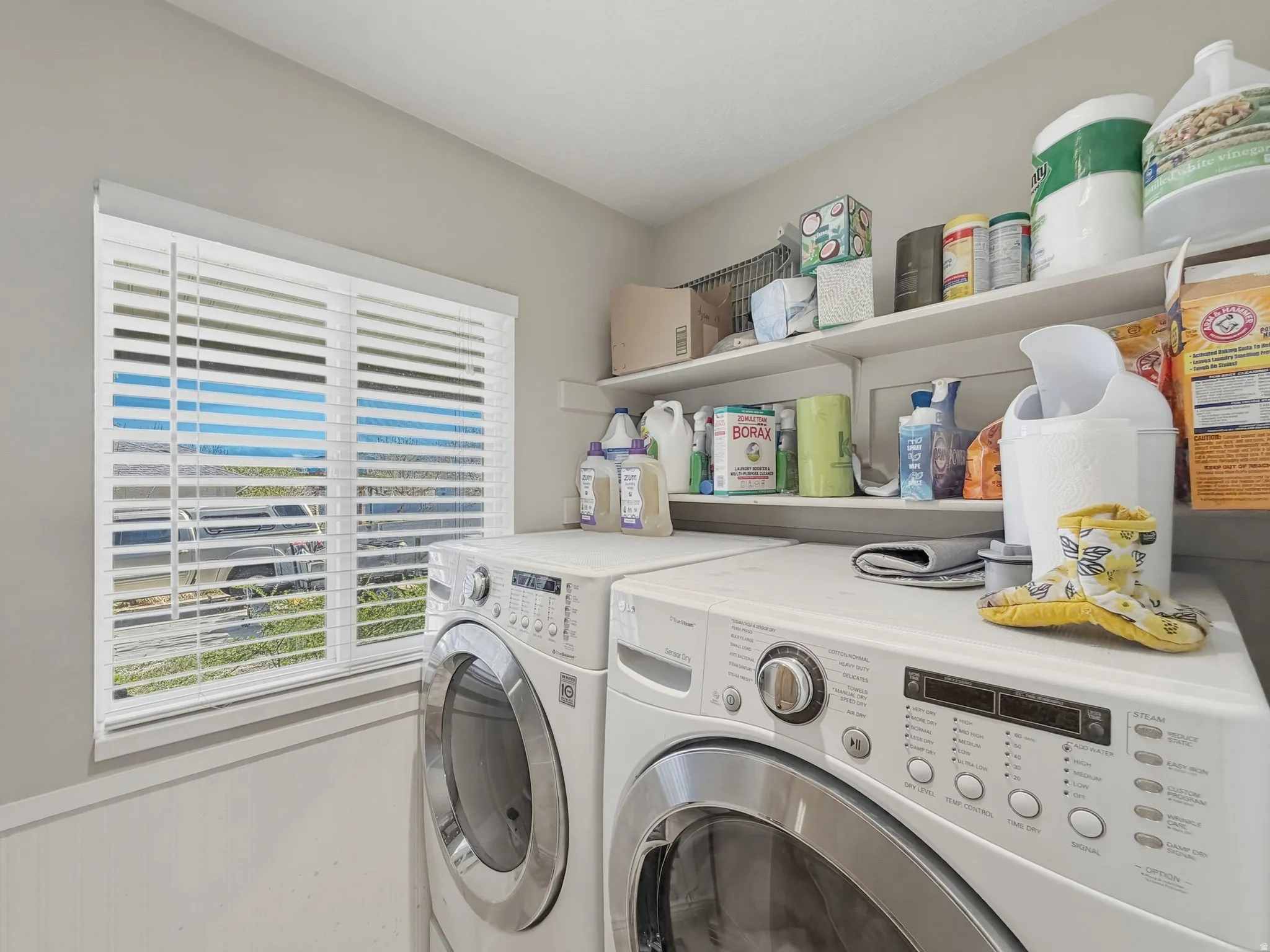 Laundry room with washer and clothes dryer and wainscoting