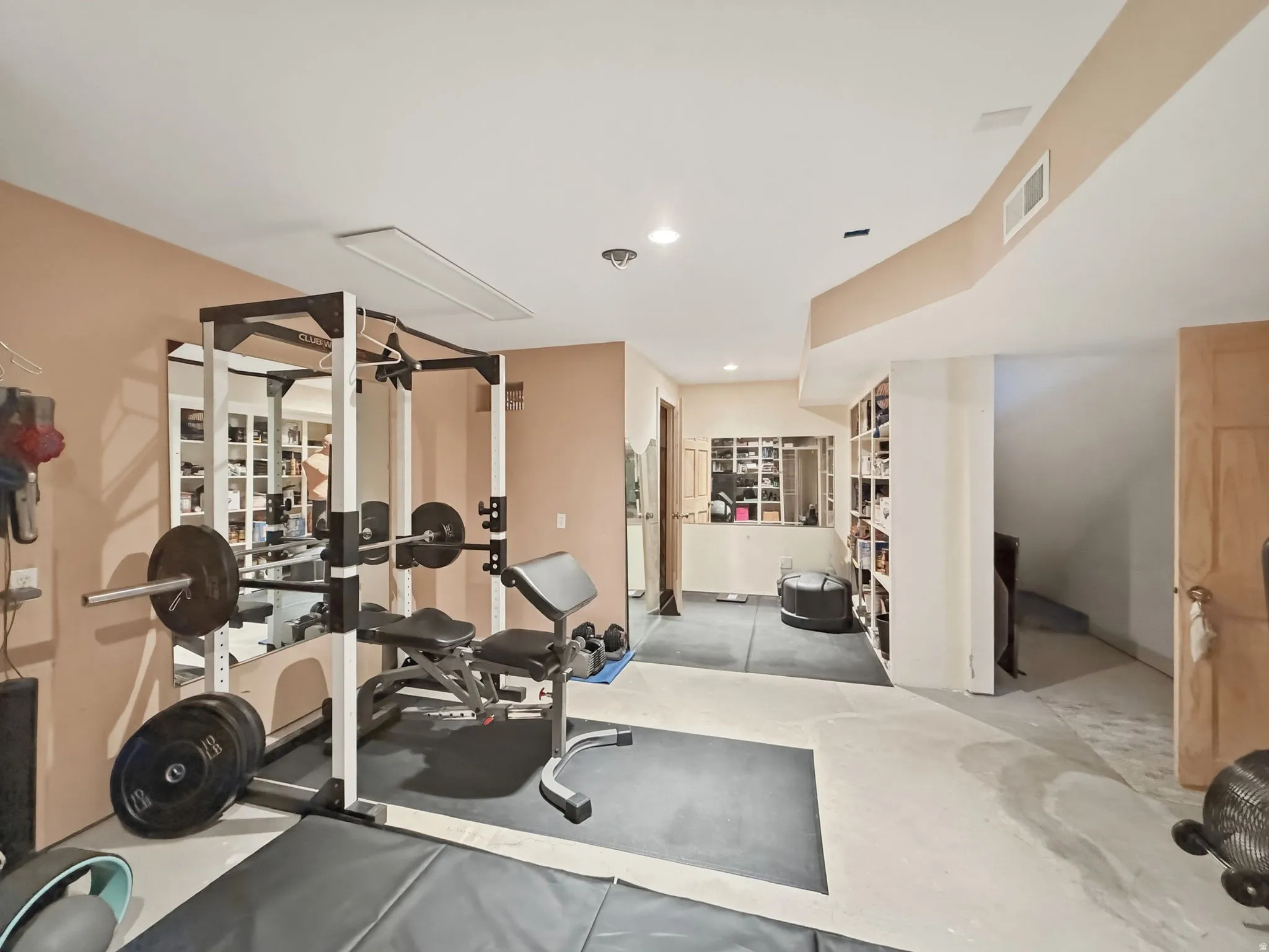 Workout area with concrete floors and recessed lighting