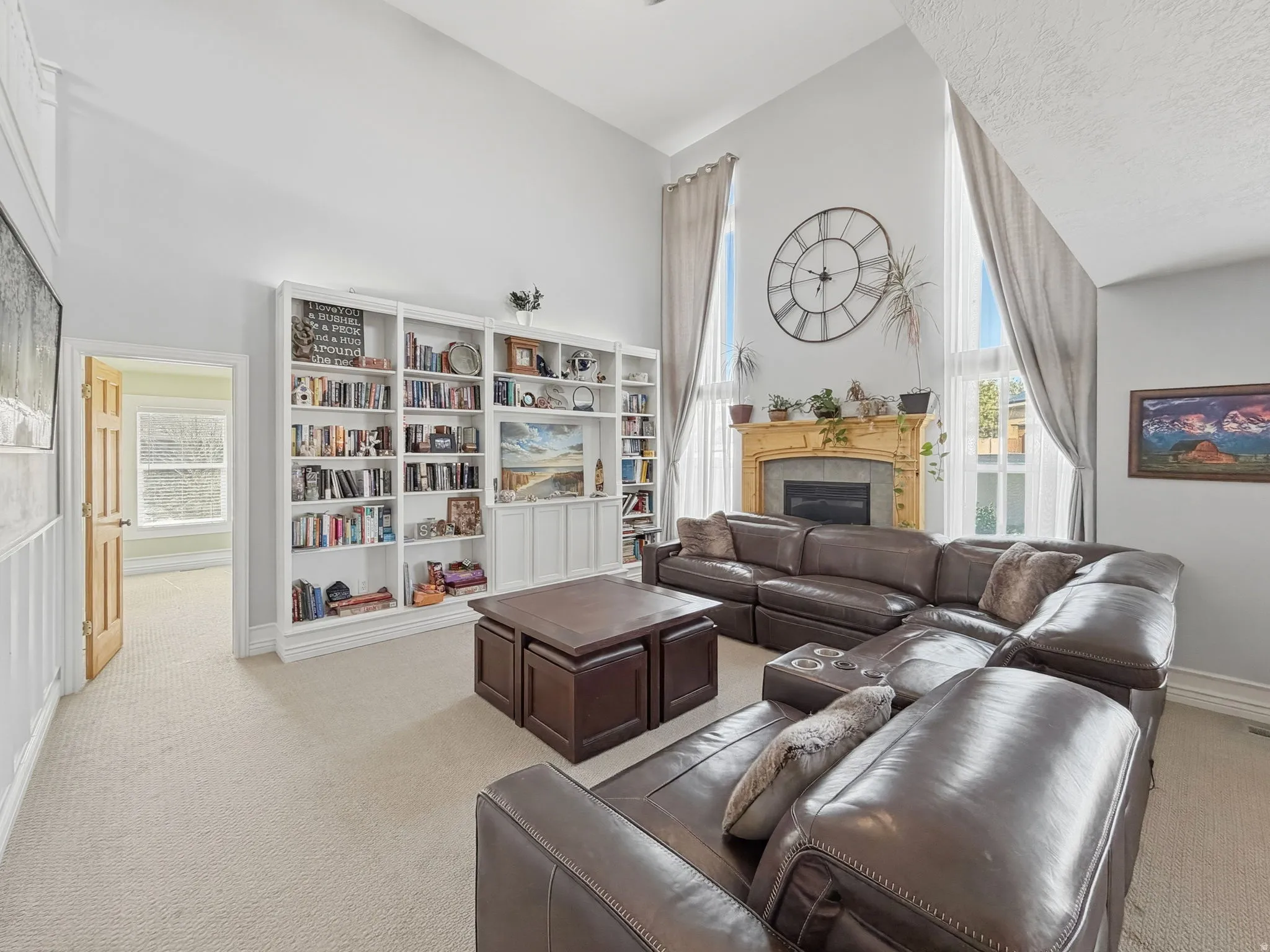 Living room with light carpet, a fireplace, and vaulted ceiling
