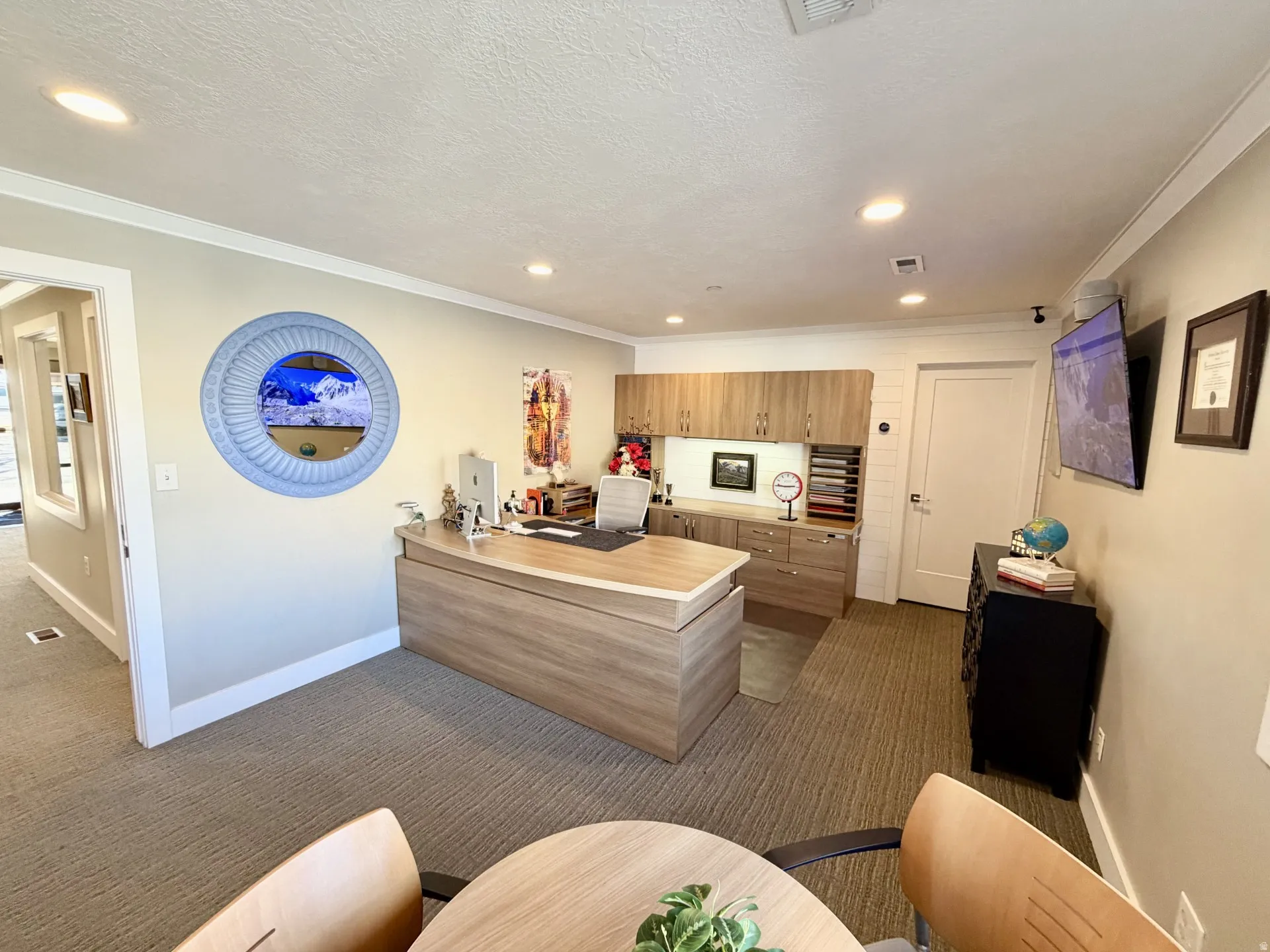Kitchen with light countertops, a peninsula, dark carpet, crown molding, and recessed lighting