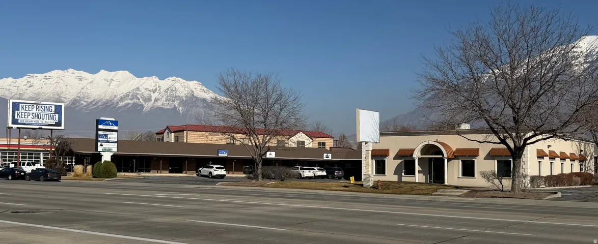 View of street with a mountain view, curbs, and sidewalks