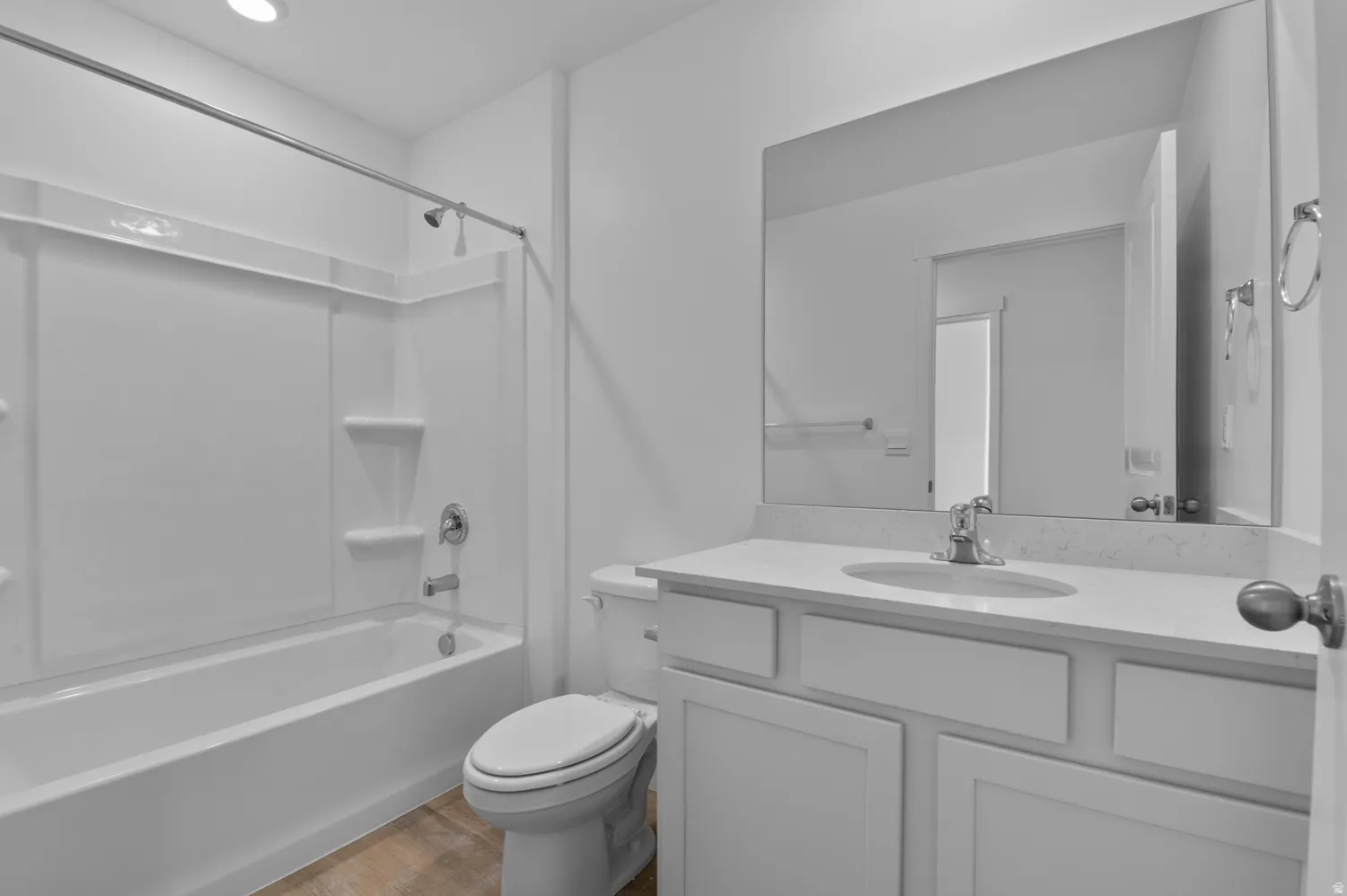 Full bath with vanity,  shower combination, and light wood-style floors