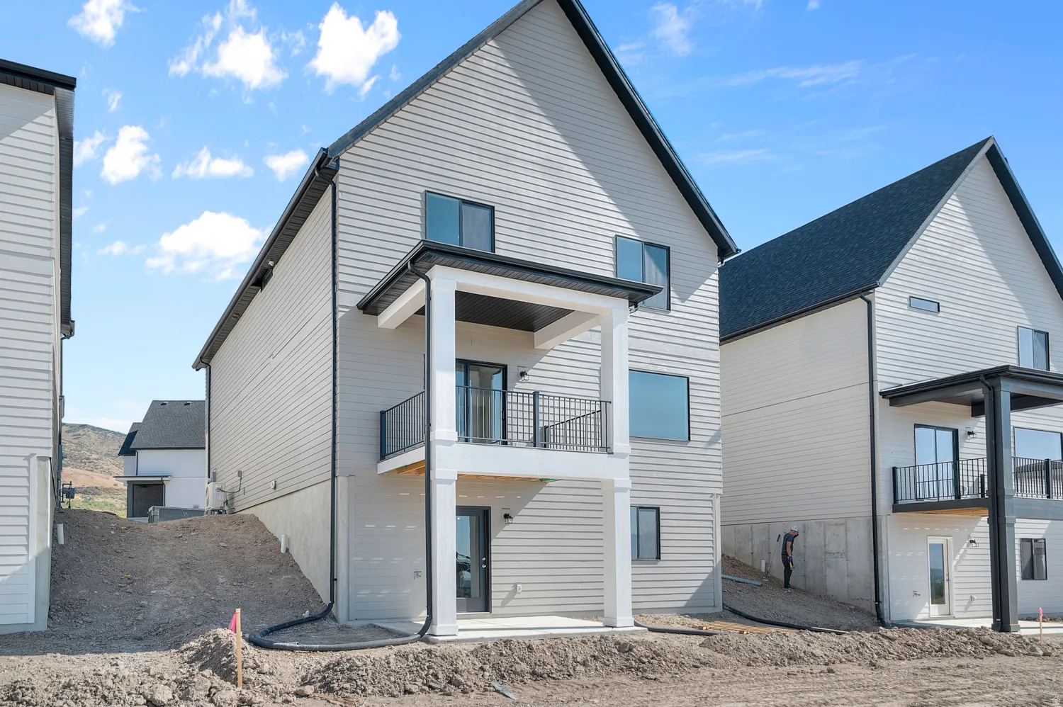 Back of property with a patio and a balcony