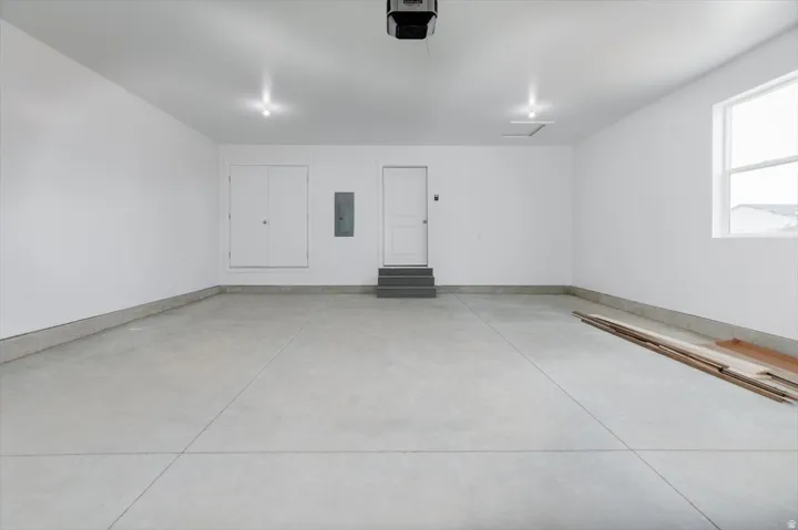 Garage with a garage door opener and electric panel