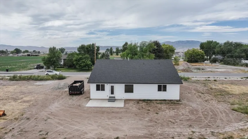 Back of property with a patio and a mountain view