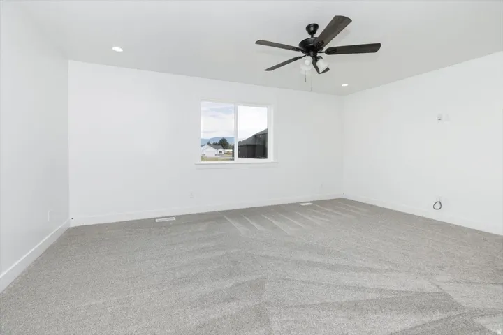 Unfurnished room with light colored carpet, ceiling fan, and recessed lighting