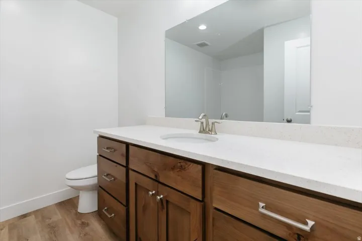 Bathroom featuring vanity, light wood-style floors, and recessed lighting