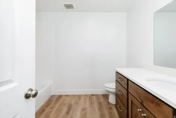 Bathroom with vanity and light wood finished floors