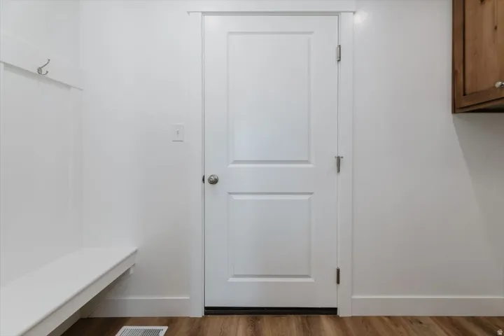 Mudroom with baseboards and wood finished floors