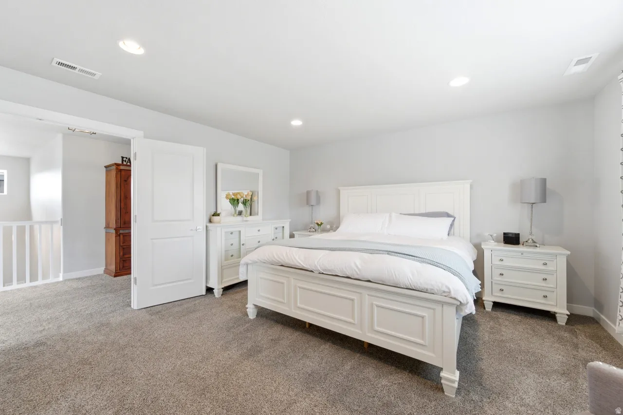 Bedroom featuring dark carpet and recessed lighting