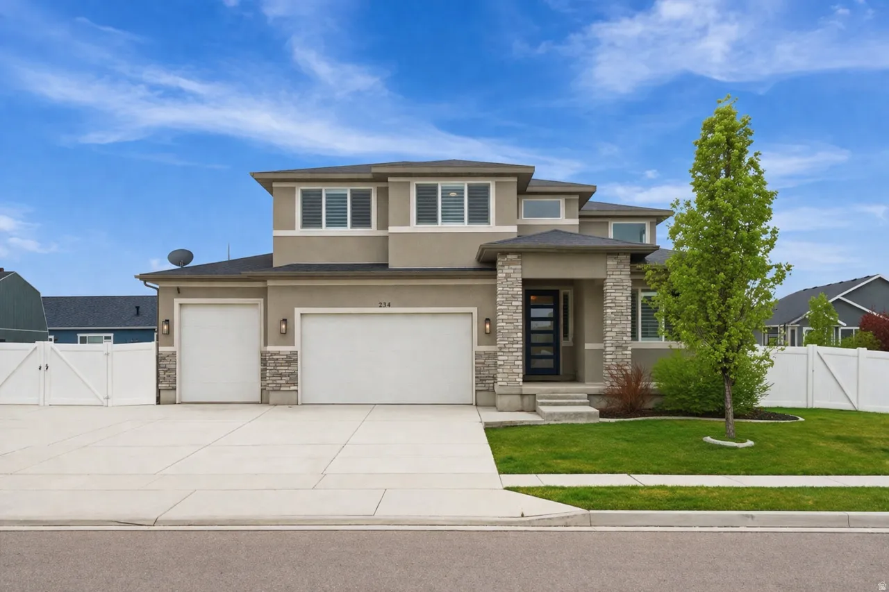 Prairie-style home featuring stucco siding, a gate, stone siding, concrete driveway, and an attached garage