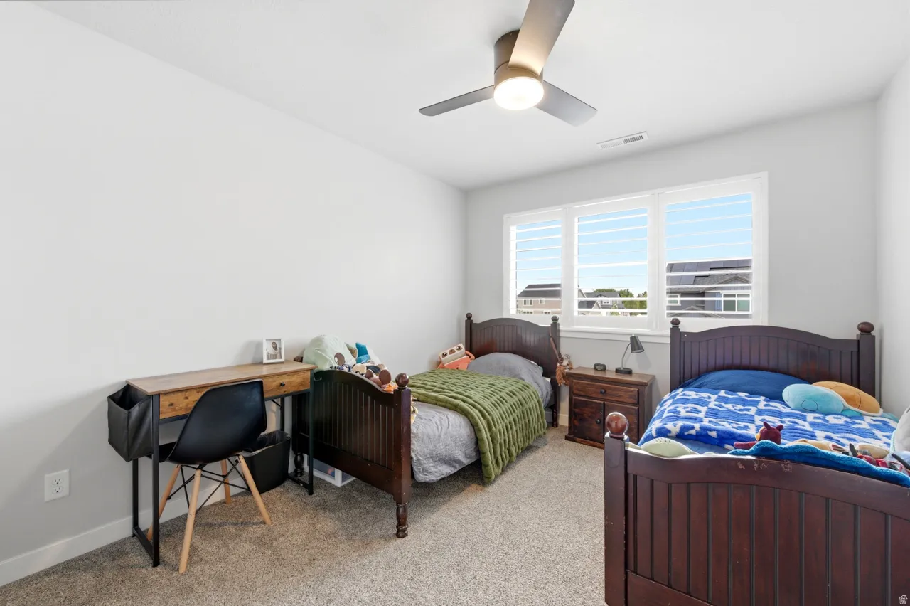 Bedroom featuring light carpet and ceiling fan