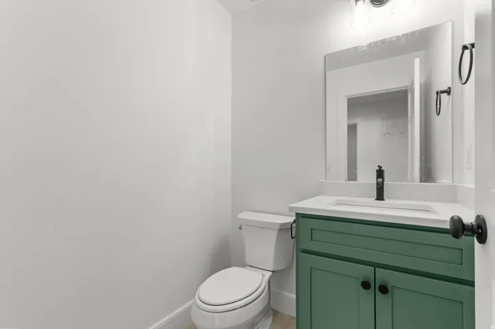 Half bath featuring vanity and toilet