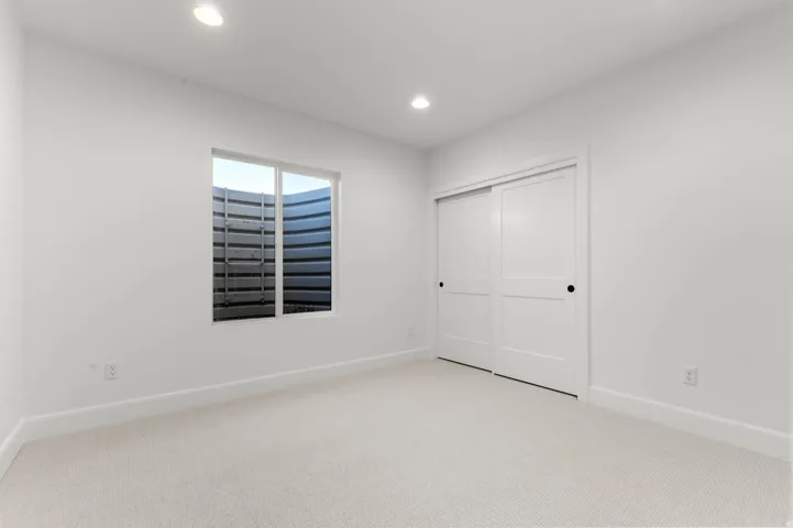 Unfurnished bedroom featuring carpet, recessed lighting, and a closet