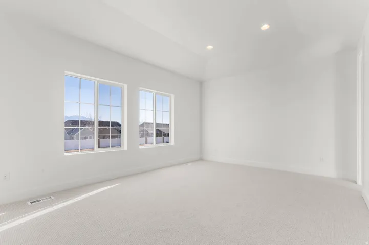 Carpeted spare room featuring recessed lighting and baseboards