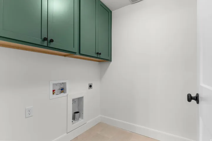 Laundry room featuring cabinet space, hookup for a washing machine, and electric dryer hookup