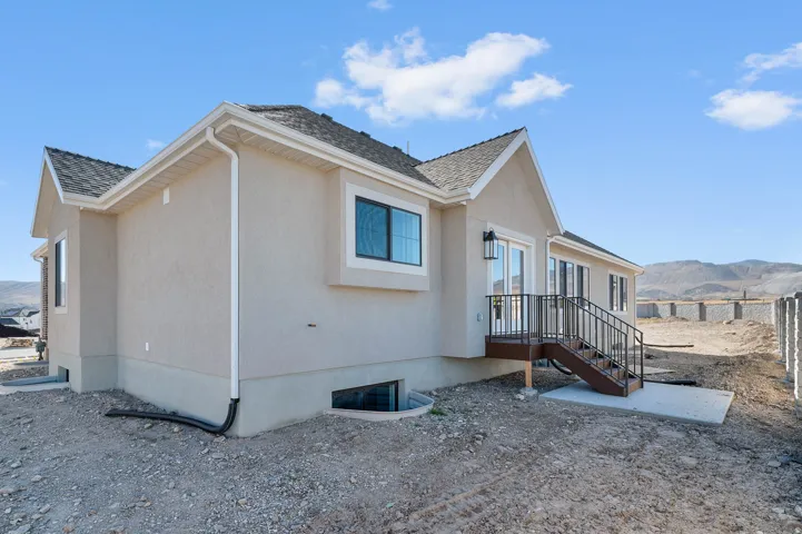 View of side of property with a mountain view and stucco siding