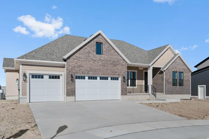 View of front of property featuring concrete driveway, a garage, covered porch, and roof with shingles