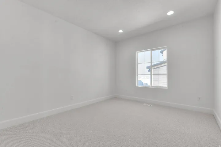 Unfurnished room featuring carpet flooring and recessed lighting